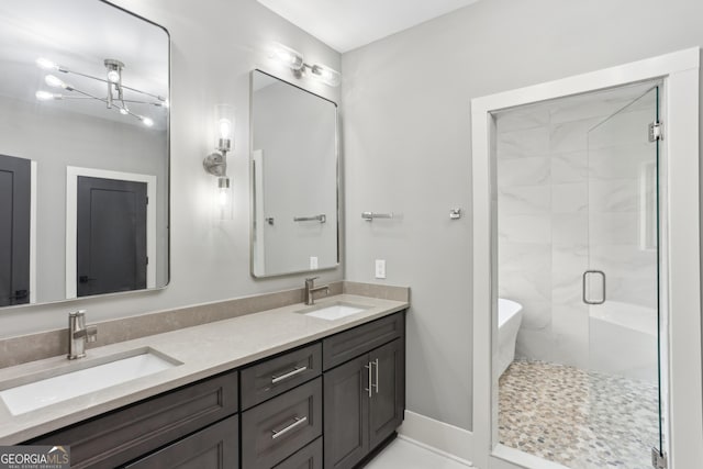 full bathroom featuring double vanity, a sink, a shower stall, and a freestanding bath