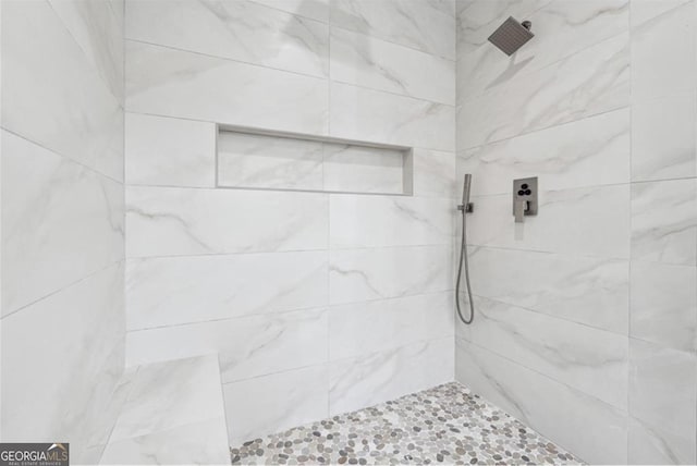 full bathroom with tiled shower