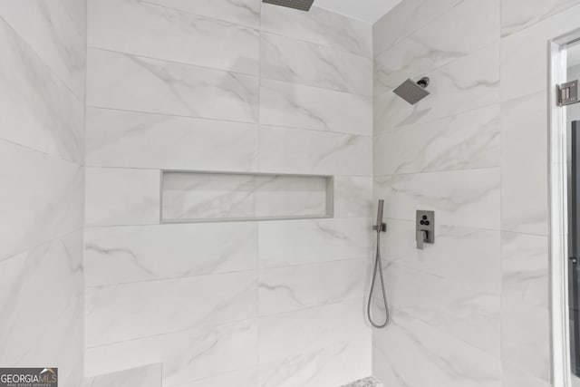 full bath featuring a tile shower