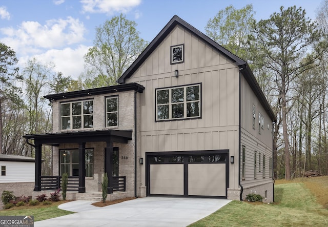 modern farmhouse featuring an attached garage, brick siding, a front lawn, board and batten siding, and driveway