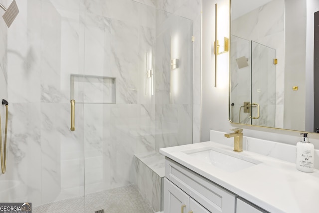 full bathroom featuring vanity and a marble finish shower
