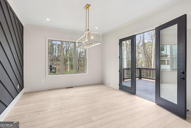 unfurnished dining area with visible vents, a chandelier, light wood finished floors, recessed lighting, and french doors