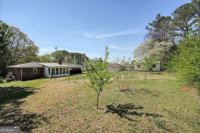 view of yard featuring a sunroom