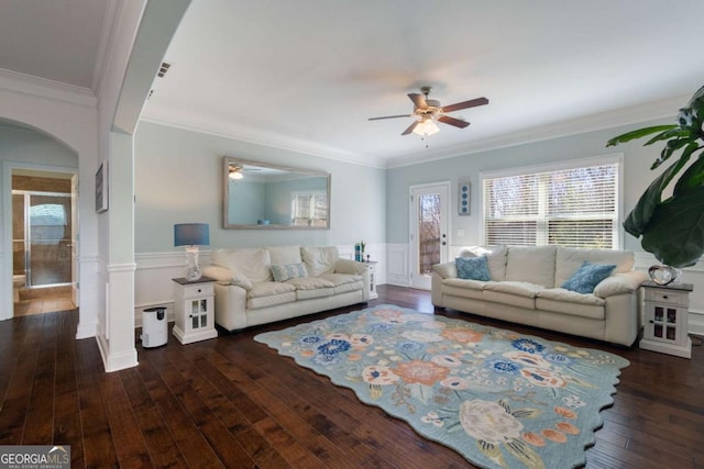 living room featuring a wealth of natural light, arched walkways, hardwood / wood-style flooring, and ceiling fan