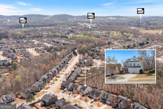 birds eye view of property featuring a mountain view and a residential view