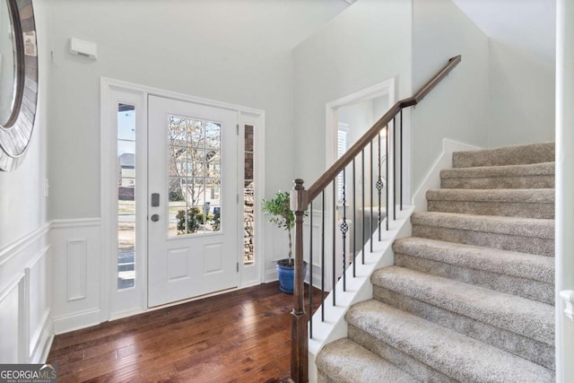 foyer entrance with dark wood-type flooring and stairway