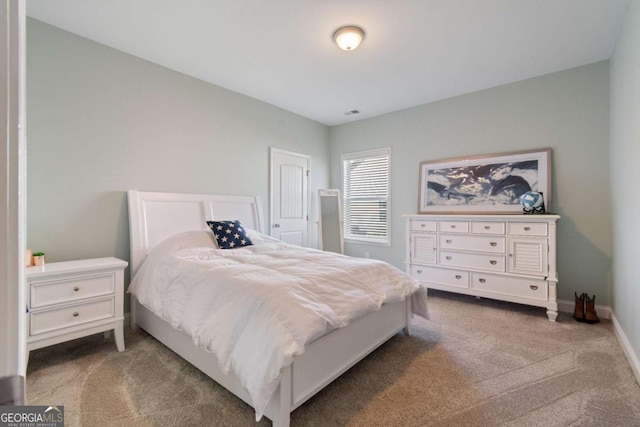 bedroom featuring baseboards and carpet