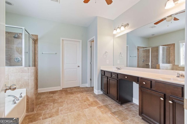 full bathroom with double vanity, a ceiling fan, a shower stall, a bath, and a sink