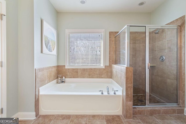 full bathroom featuring a stall shower and a garden tub