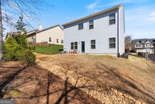 back of house featuring fence