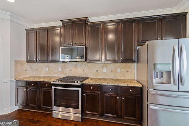 kitchen featuring appliances with stainless steel finishes, dark brown cabinetry, light stone counters, and dark wood-style floors