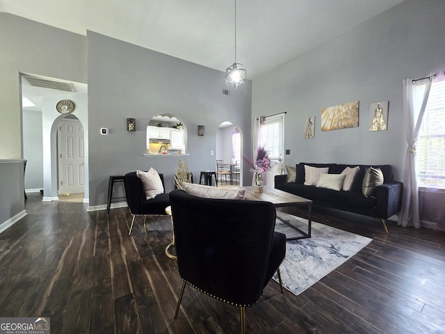 135 Grist Mill Ln SE, Calhoun, GA 30701 - living room featuring arched walkways, high vaulted ceiling, a wealth of natural light, and wood finished floors