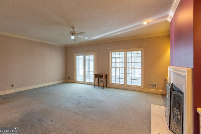 115 Flagstop Run, Fayetteville, GA 30215 - unfurnished living room with a ceiling fan, a textured ceiling, carpet flooring, a fireplace with flush hearth, and crown molding