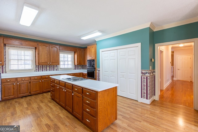 115 Flagstop Run, Fayetteville, GA 30215 - kitchen featuring black appliances, brown cabinetry, light wood-style flooring, light countertops, and ornamental molding