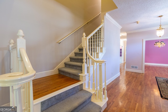 115 Flagstop Run, Fayetteville, GA 30215 - staircase featuring a textured ceiling, wood finished floors, and ornamental molding