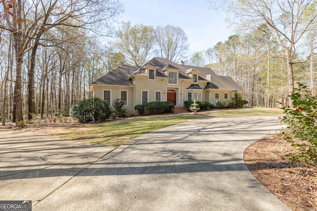 115 Flagstop Run, Fayetteville, GA 30215 - traditional home with driveway, stucco siding, a chimney, and a front lawn