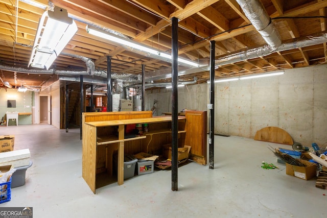 115 Flagstop Run, Fayetteville, GA 30215 - unfinished basement featuring gas water heater and a workshop area