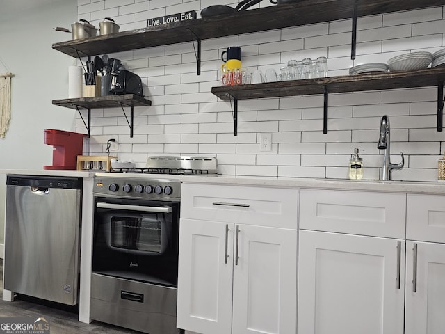 215 Piedmont Ave NE Unit 304, Atlanta, GA 30308 - kitchen featuring a sink, white cabinetry, decorative backsplash, open shelves, and appliances with stainless steel finishes