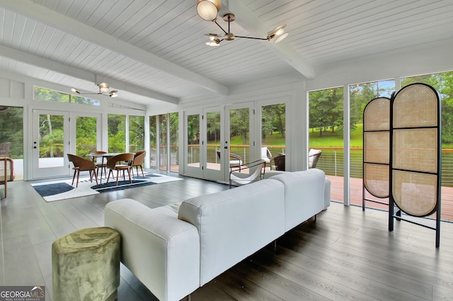 sunroom / solarium featuring french doors, beamed ceiling, and a chandelier