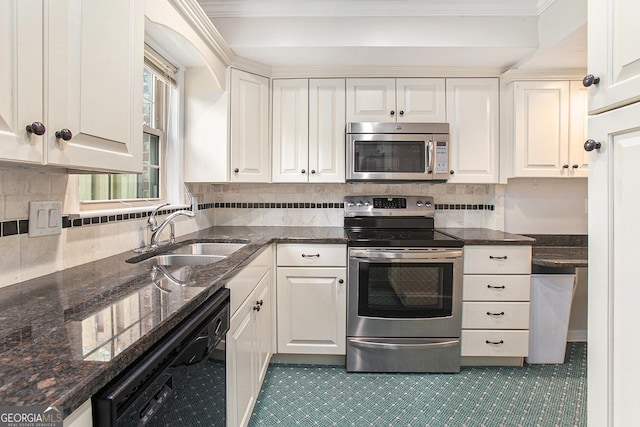 kitchen with white cabinets, a sink, tasteful backsplash, and appliances with stainless steel finishes