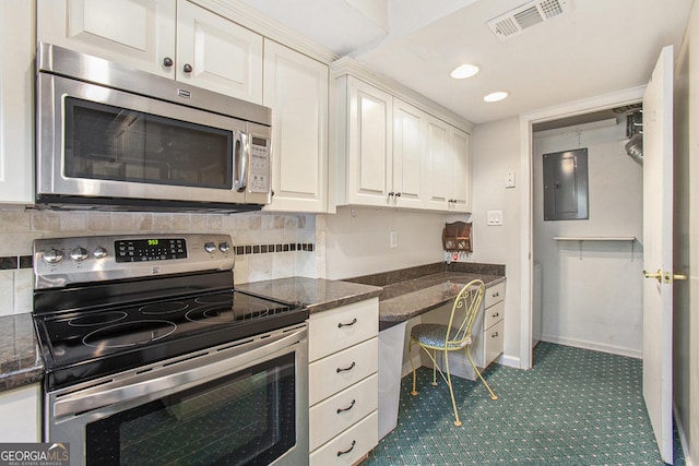 kitchen with stainless steel appliances, backsplash, visible vents, white cabinets, and electric panel