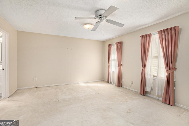unfurnished room featuring ceiling fan, carpet flooring, and a textured ceiling
