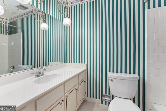 full bath with wallpapered walls, toilet, vanity, and washtub / shower combination