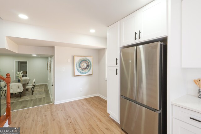 1749 Lauranceae Way, Riverdale, GA 30296 - kitchen with white cabinetry, light wood-style flooring, recessed lighting, and freestanding refrigerator