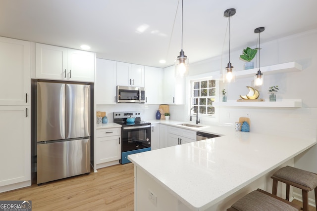 1749 Lauranceae Way, Riverdale, GA 30296 - kitchen with white cabinetry, a sink, appliances with stainless steel finishes, and a peninsula