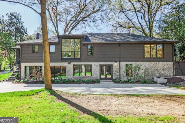 1718 Barnesdale Way NE, Atlanta, GA 30309 - back of property featuring french doors, stone siding, and a chimney