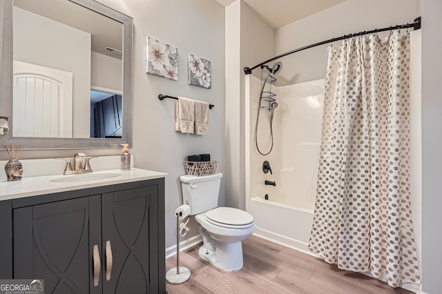 full bath featuring wood finished floors, visible vents, toilet, vanity, and shower / bath combo