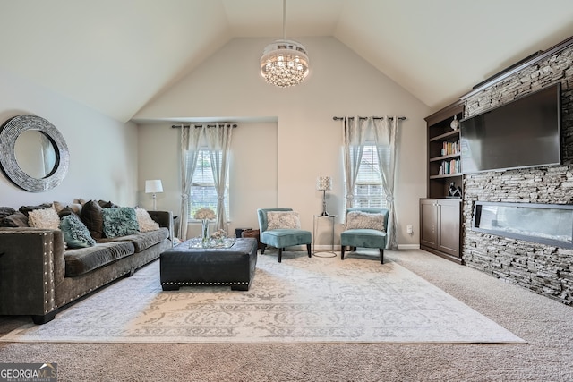 carpeted living area with a chandelier, a stone fireplace, baseboards, and high vaulted ceiling