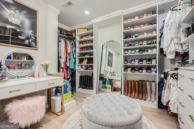 spacious closet with light wood-style floors and visible vents
