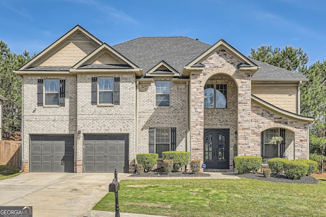 view of front of house featuring driveway, a shingled roof, a front yard, a garage, and brick siding