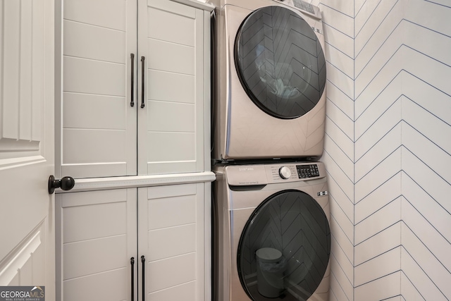 laundry area with stacked washing maching and dryer