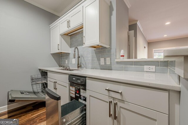 2921 Lenox Rd NE Unit 113, Atlanta, GA 30324 - kitchen featuring crown molding, backsplash, white cabinetry, dishwasher, and recessed lighting