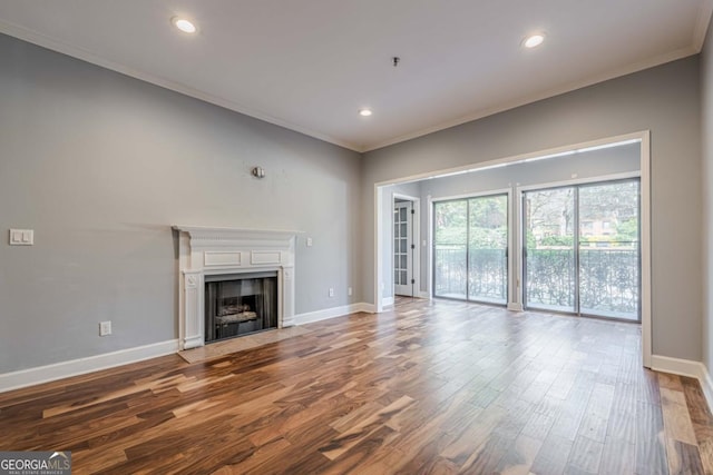 2921 Lenox Rd NE Unit 113, Atlanta, GA 30324 - unfurnished living room featuring ornamental molding, wood finished floors, recessed lighting, and a fireplace with flush hearth