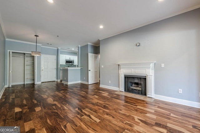 2921 Lenox Rd NE Unit 113, Atlanta, GA 30324 - unfurnished living room featuring ornamental molding, dark wood-style flooring, recessed lighting, and a fireplace with flush hearth