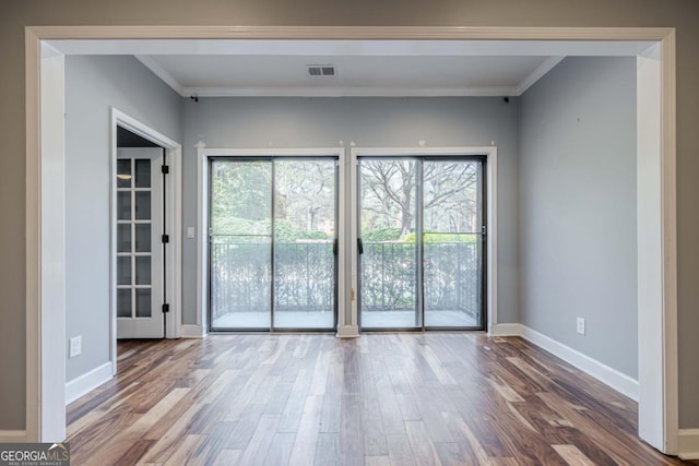 2921 Lenox Rd NE Unit 113, Atlanta, GA 30324 - spare room featuring wood finished floors and crown molding