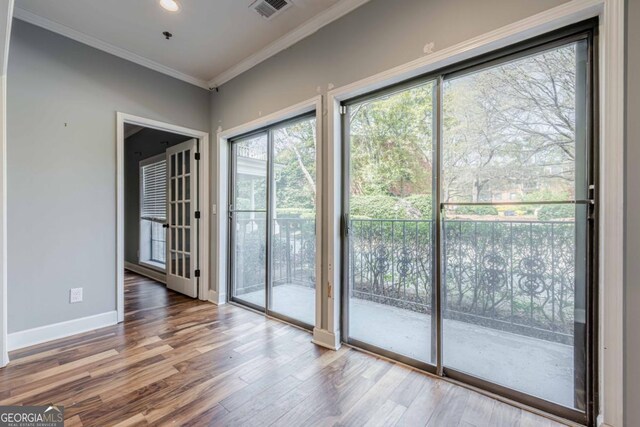 2921 Lenox Rd NE Unit 113, Atlanta, GA 30324 - doorway with crown molding and wood finished floors