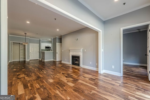 2921 Lenox Rd NE Unit 113, Atlanta, GA 30324 - unfurnished living room featuring dark wood finished floors, crown molding, a fireplace with flush hearth, and recessed lighting