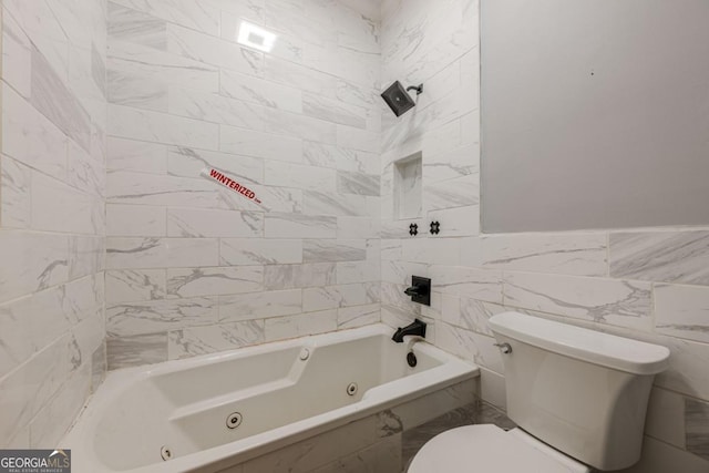 2921 Lenox Rd NE Unit 113, Atlanta, GA 30324 - bathroom with tile walls and a combined bath / shower with jetted tub