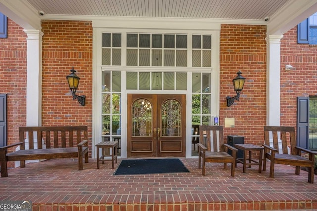 2921 Lenox Rd NE Unit 113, Atlanta, GA 30324 - entrance to property featuring brick siding, french doors, and a porch