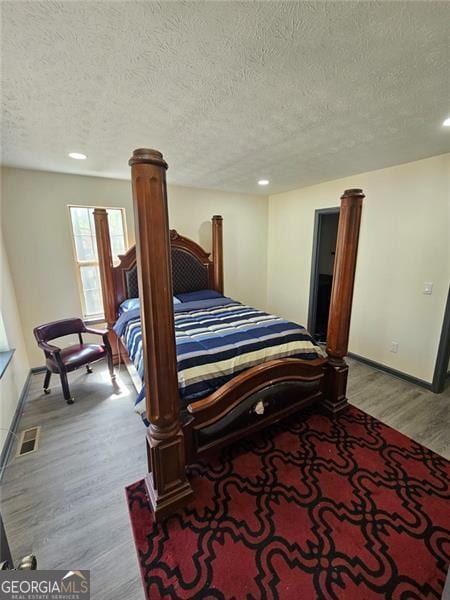 2565 Cloud, Decatur, GA 30034 - bedroom with light wood-style flooring, a textured ceiling, baseboards, and recessed lighting