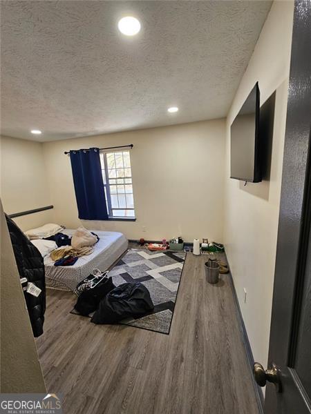 2565 Cloud, Decatur, GA 30034 - unfurnished bedroom featuring wood finished floors, a textured ceiling, and recessed lighting