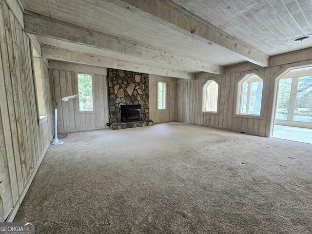 unfurnished living room with carpet flooring, a fireplace, and visible vents