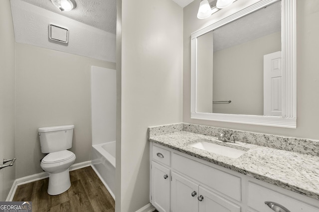 full bath with toilet, vanity, baseboards, and wood finished floors