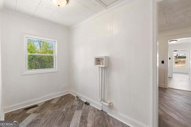 laundry area with a healthy amount of sunlight, hookup for a washing machine, laundry area, and crown molding