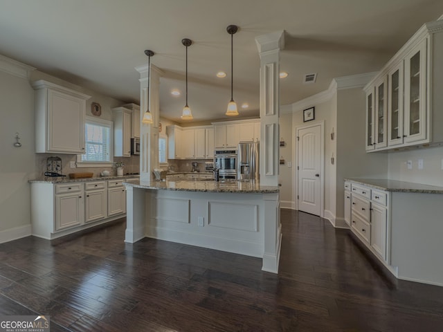 kitchen featuring baseboards, appliances with stainless steel finishes, white cabinets, and visible vents