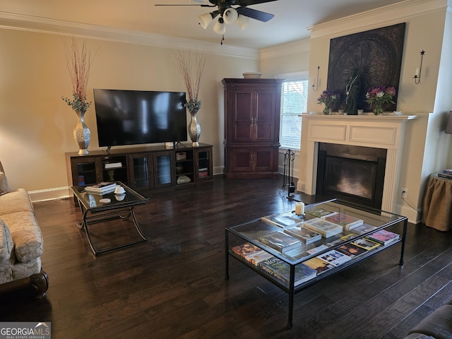 living area featuring ceiling fan, crown molding, a fireplace, wood finished floors, and baseboards